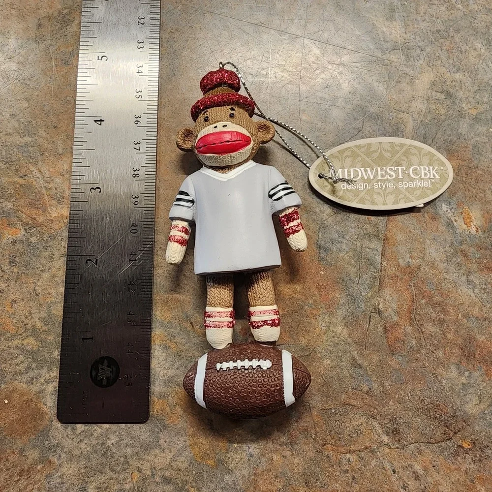 Christmas ornament sock monkey wearing Gray jersey standing on Football